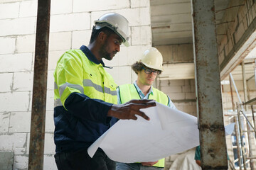 Architect and construction engineer or surveyor discussion plans and blueprints