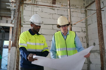 Architect and construction engineer or surveyor discussion plans and blueprints