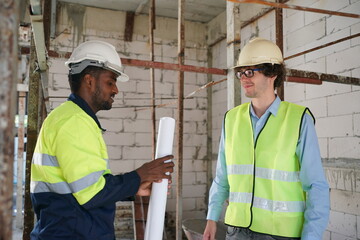 Architect and construction engineer or surveyor discussion plans and blueprints