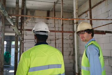 Architect and construction engineer or surveyor discussion plans and blueprints