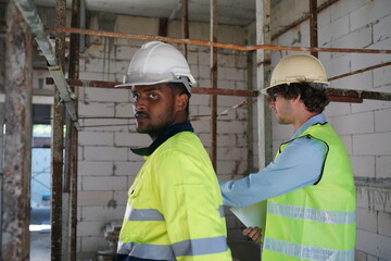 Architect and construction engineer or surveyor discussion plans and blueprints