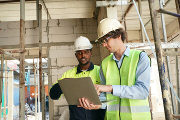 Architect and construction engineer or surveyor discussion plans and blueprints