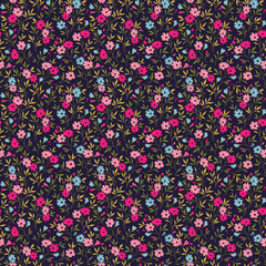 Vintage seamless floral pattern. Liberty style background of small colorful flowers. Small flowers scattered over a dark blue background. Stock vector for printing on surfaces. Abstract flowers. © ann_and_pen