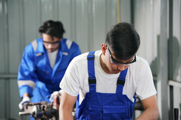 Workers changing and repair part of wheels at the car service