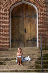 A Hungry Homeless Abandoned Runaway Child Looks For Food And Shelter In Front Of A Church