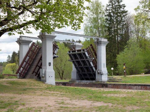 Dombrovka, Belarus - 16 May 2022: Draw bridge of Augustow canal. Shipping sluice. Hydraulic engineering installation