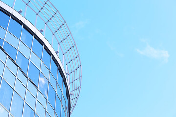 Architectural detail of the facade with multiple reflections of other buildings and the sun. Modern building. Architecture background