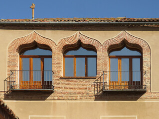 Window and balconies with brick ogee arches in the historic city of Segovia. Spain. 