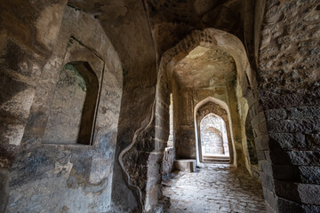 Dilapidates walls and arches in the ruins of the ancient historic Golconda Fort in Hyderabad.