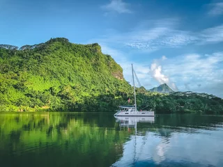 Acrylic prints Bora Bora, French Polynesia White yacht anchored near mountain coast bay. Sailing boat stop at tropical Island blue sea lagoon. Travel, summer cruise, recreation, leisure activity. French Polynesia Bora Bora exotic luxury tour.