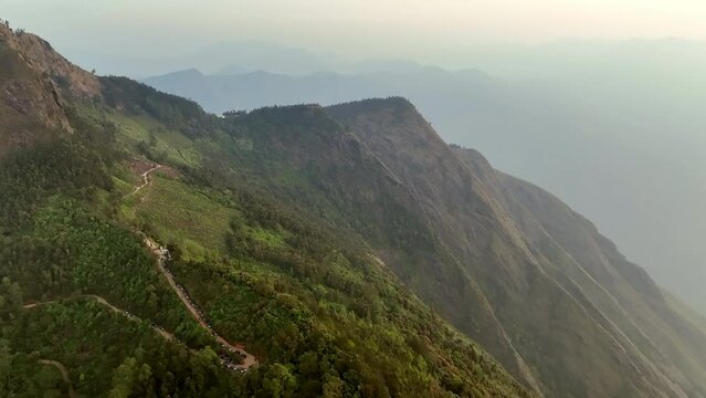 Aerial Forward Beautiful Shot Of Natural Mountain Range During Foggy Weather - Munnar, Kerala