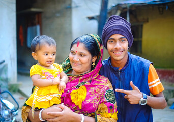 Mother with child, Bangladeshi family members wearing traditional dresses