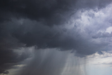 The dark sky with heavy clouds converging and a violent storm before the rain.Bad or moody weather...