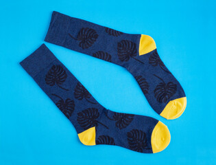Long sock for men with monstera leaves in blue and yellow