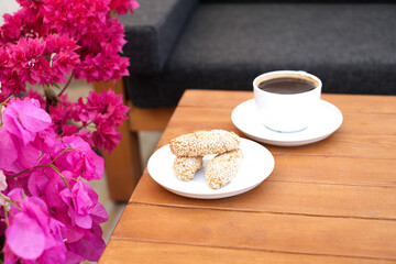 cup of coffee with cookies and flowers