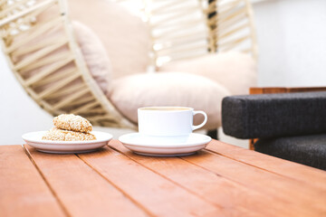 Cup of tea with sesame cookies on the table