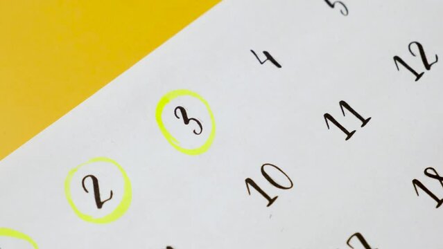 The hand circles the date in the calendar with a marker. 3th of the month.