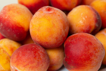 There is a dish of peaches on the table