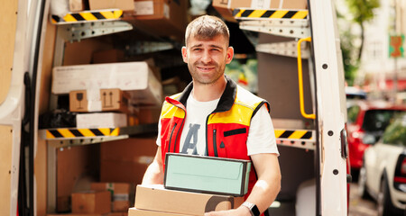 The happy courier took the boxes and wants to leave to deliver them