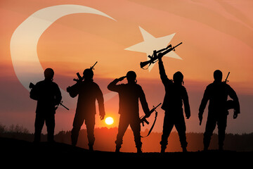 Silhouettes of soldiers on a background of Turkey flag and the sunset or the sunrise. Concept of...