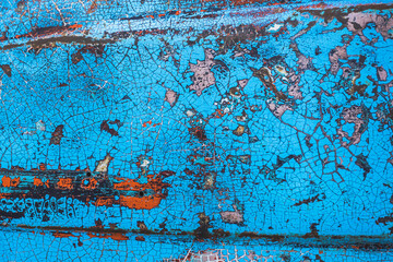 Enamelled colorful cracked and peeling surface of old motorcycle. Rusty metal surface with blue...