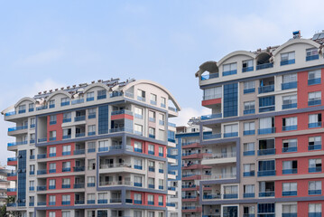 Residential complex of several houses against the sky.