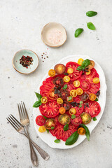 Salad with colorful tomatoes and basil