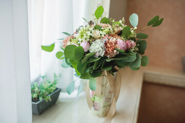 Bright Beautiful bridal bouquet with roses and ribbon