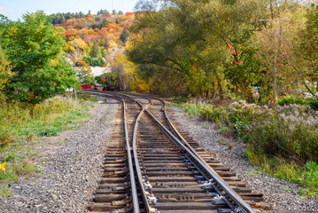 Fototapeta na wymiar Switches along railway tracks in the countryside on a sunny autumn day
