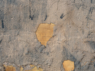 Grunge texture of an old wall with a peeling light-blue paint and stucco