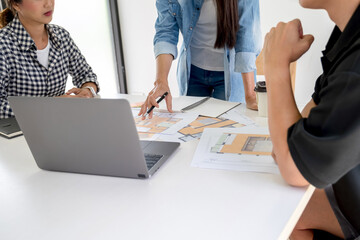 Architect design works drawing sketches, plans, blueprints and building architectural construction models in an architect studio.