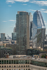 Fototapeta na wymiar London, UK - July 4, 2022: Seen from London Eye. One Blackfriars high rise modern glass residential building and South Bank Tower left in urban cityscape under blue cloudscape.