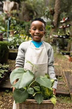 Portrait of happy african american boy in garden