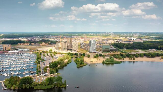 Almere Poort - new residential neighborhood in Almere, Flevoland, The Netherlands with its luxury appartment buildings and marina. Aerial hyperlapse.