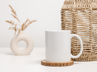 Mockup mug or coffee cup with home decor at the background. White mug for logo, text and design...