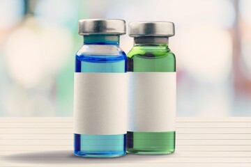 medical liquid for injection in a glass vial on the desk