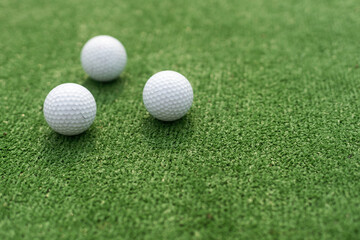 A golf club and a ball during a mini golf game