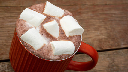 Hot chocolate with marshmallows in a red mug. Close up