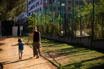 Fototapeta na wymiar A Mother and son walking to school in daily morning