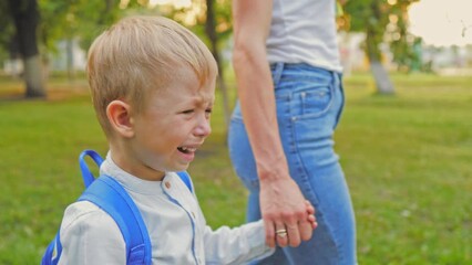 Close-up face of little upset child. Schoolboy problem with school backpack, disappointment stress kid emotion, child education time.