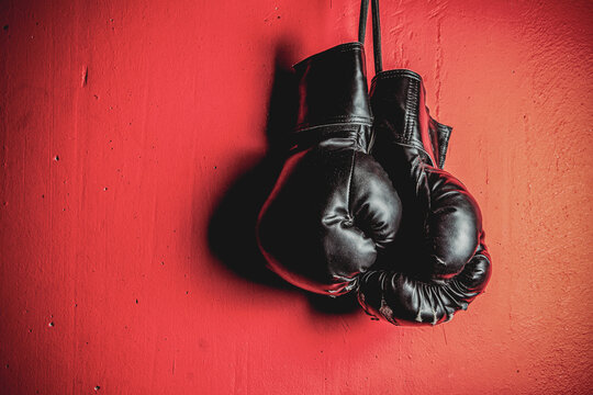 Boxing Gloves hanging on the red vintage wall