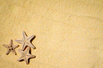 Fototapeta na wymiar Vacations and summer time concept with starfish and clear yellow beach sand. Sea and ocean vacation background