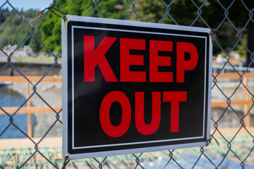 Keep Out sign on chain-link fence at construction site