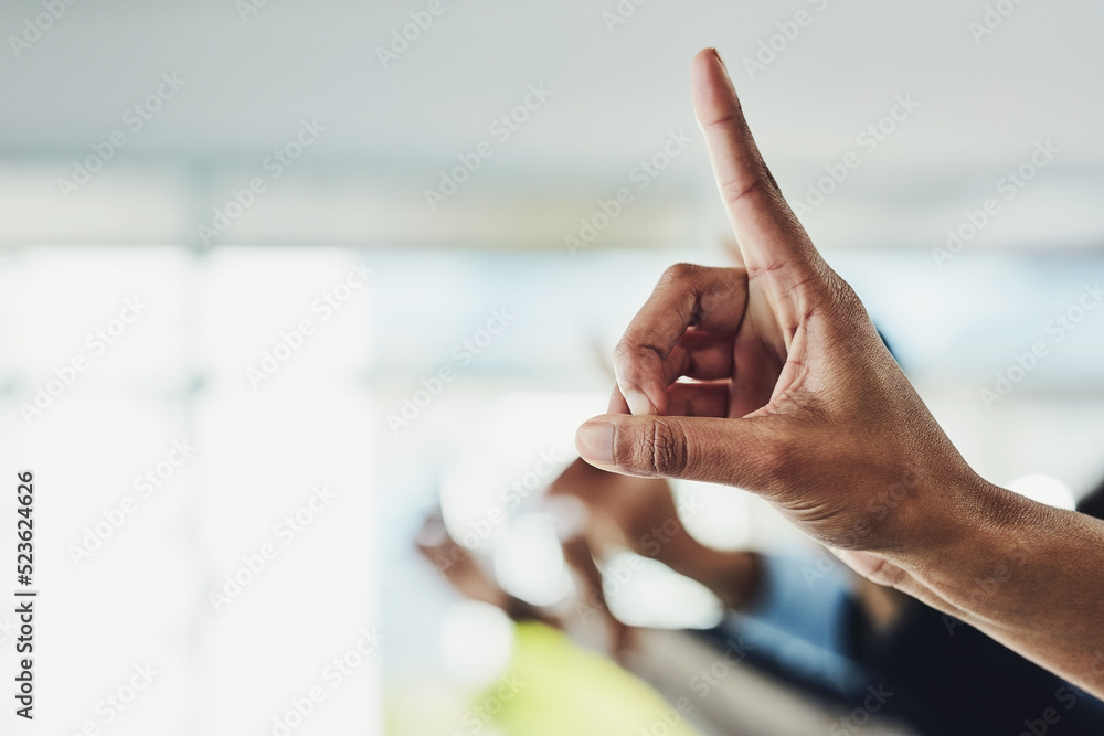 Poster raising hand and finger to ask a business question in a modern office. closeup of group of colleague