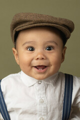 Cute funny baby dressed up like a newsboy 