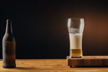 glass of beer with foam half full