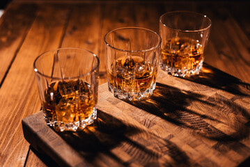 Whiskey glass on wooden background