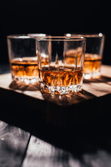 Whiskey glass on wooden background