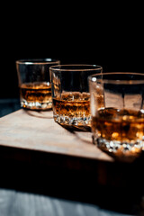 Whiskey glass on wooden background