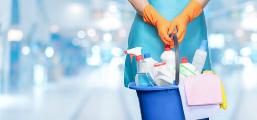 Cleaner holding a bucket of cleaning products for cleaning .